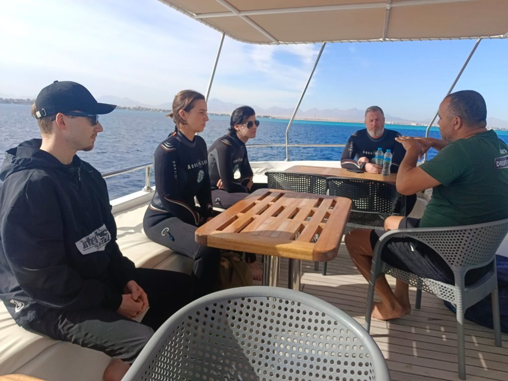 Instructor explaining dive gear to students during the Open Water Diver course