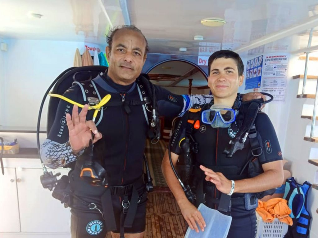 Instructor explaining dive gear to students during the Open Water Diver course