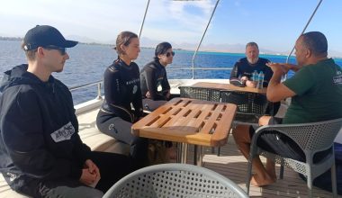 Instructor explaining dive gear to students during the Open Water Diver course
