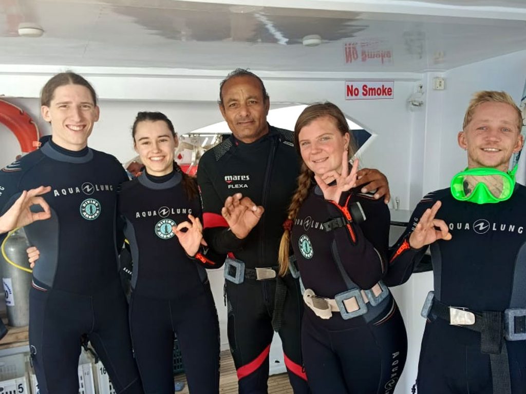 Dive boat in Hurghada with divers gearing up for a Red Sea dive Diving Hurghada Prices