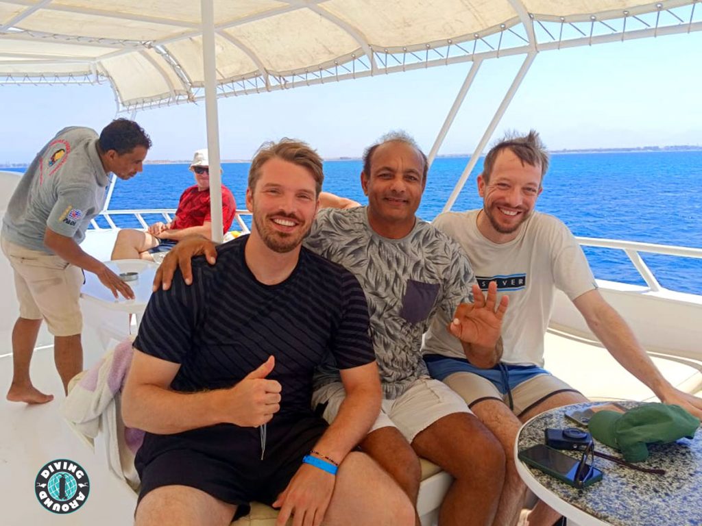 Happy diver about to backroll into the clear blue water on a daily dive trip