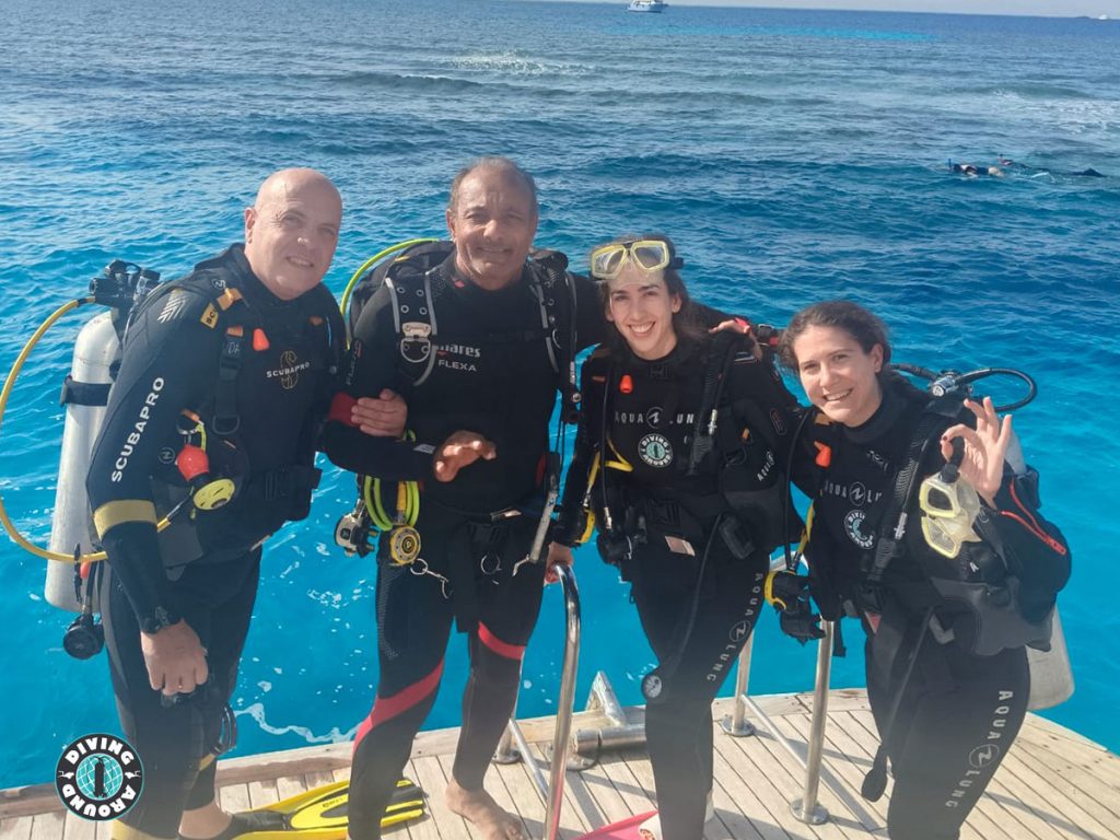 Happy diver about to backroll into the clear blue water on a daily dive trip